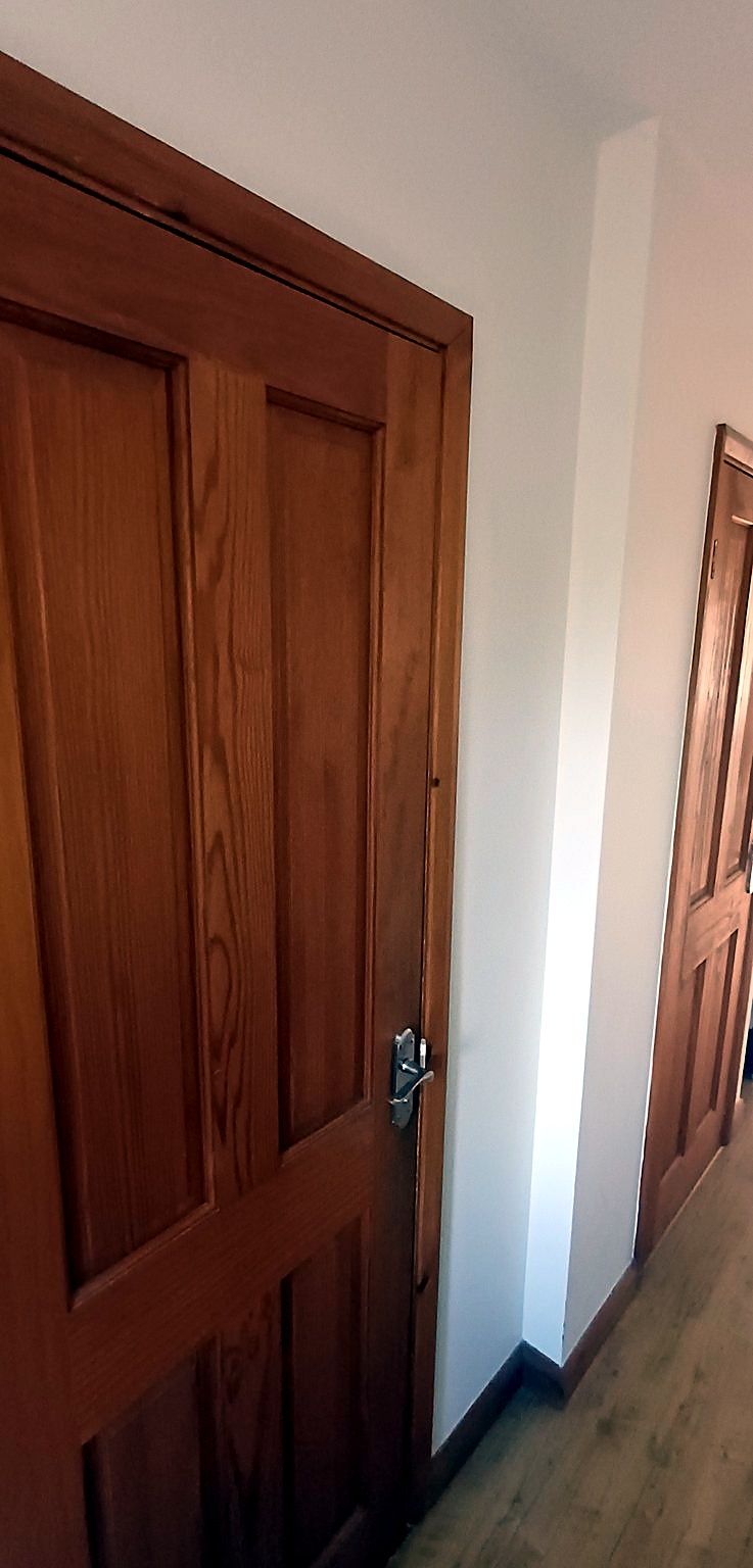 Panelled wooden doors hung in a hallway